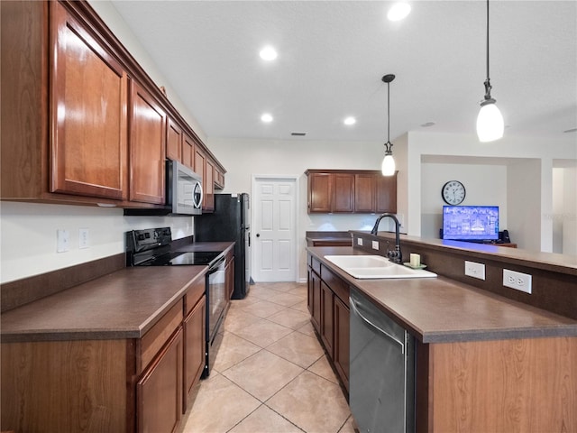 kitchen featuring sink, hanging light fixtures, a center island with sink, light tile patterned floors, and black appliances