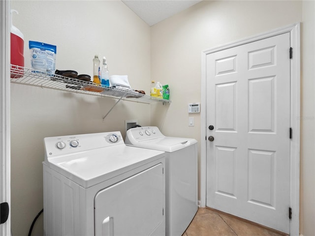 laundry room with light tile patterned floors and separate washer and dryer