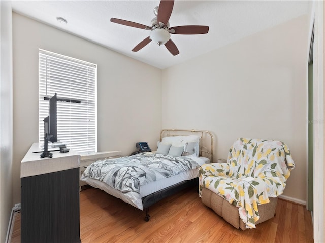 bedroom with ceiling fan and hardwood / wood-style floors