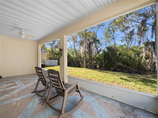 sunroom featuring ceiling fan