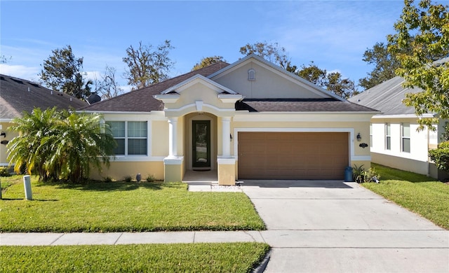 view of front facade with a front yard and a garage