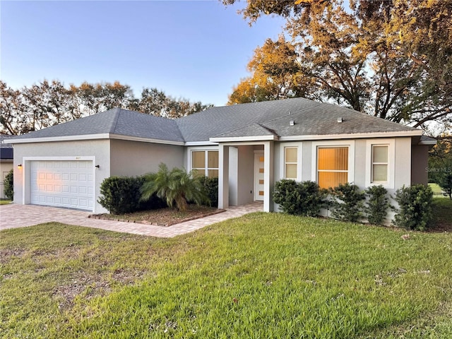 ranch-style home featuring a front lawn and a garage