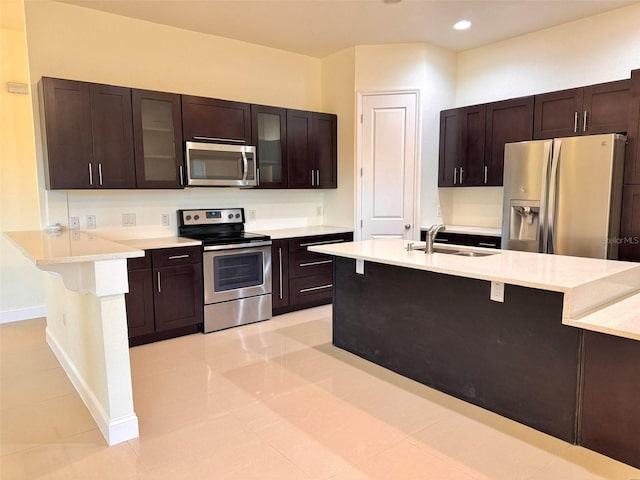 kitchen featuring dark brown cabinets, sink, and appliances with stainless steel finishes