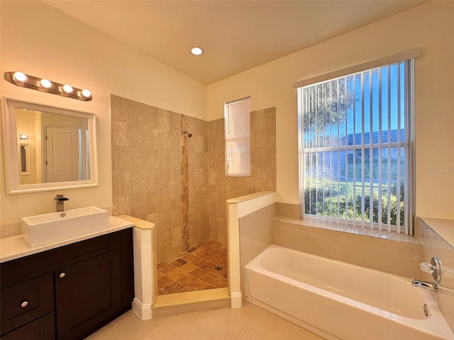 bathroom with tile patterned flooring, vanity, and independent shower and bath