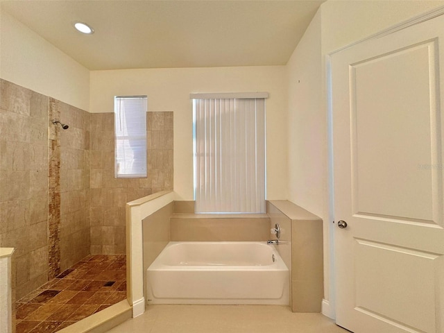 bathroom with tile patterned floors and separate shower and tub