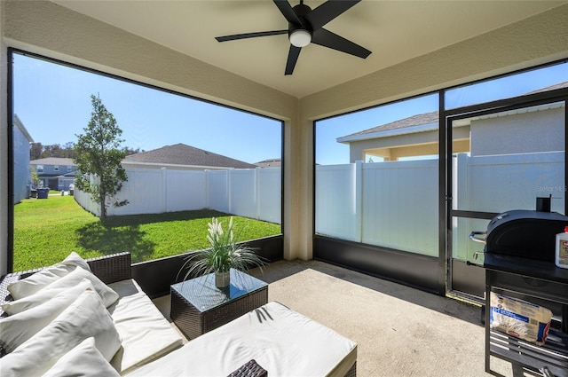 sunroom featuring ceiling fan