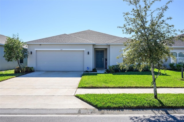 ranch-style house with a garage and a front lawn