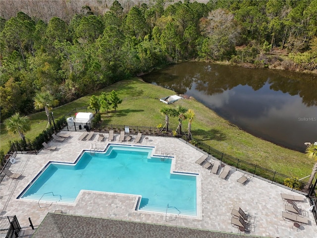 view of swimming pool with a water view, a yard, and a patio