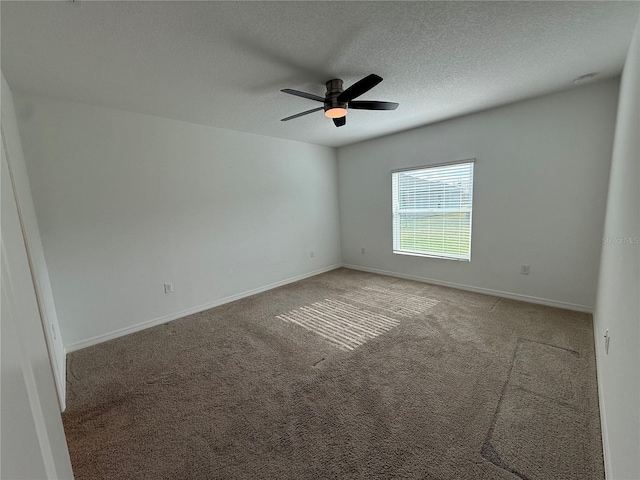 spare room with carpet, a textured ceiling, and ceiling fan