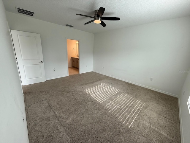 unfurnished bedroom featuring ceiling fan, connected bathroom, and carpet