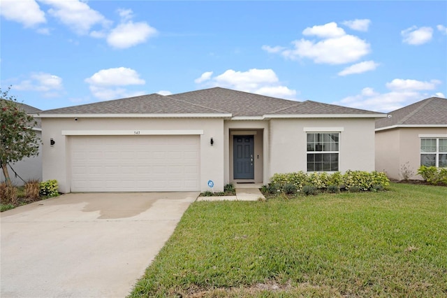 view of front of property with a garage and a front yard