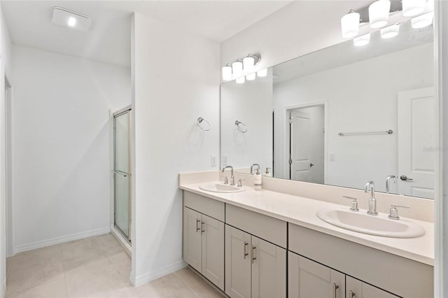 bathroom featuring walk in shower, vanity, and tile patterned flooring