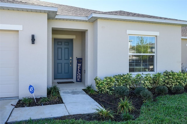 view of exterior entry featuring a garage