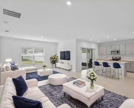 living room with recessed lighting and visible vents