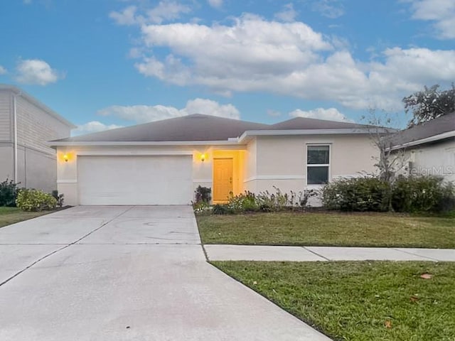 view of front of property with a front yard and a garage