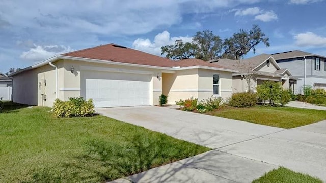 view of front facade with a garage and a front lawn