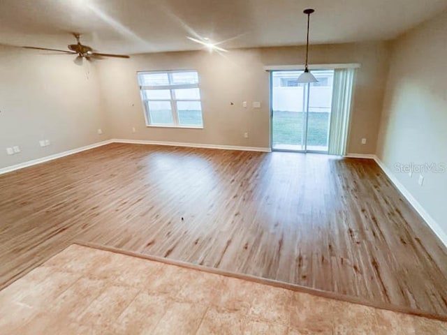 empty room featuring hardwood / wood-style flooring and ceiling fan