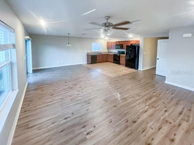 unfurnished living room with ceiling fan and light hardwood / wood-style floors