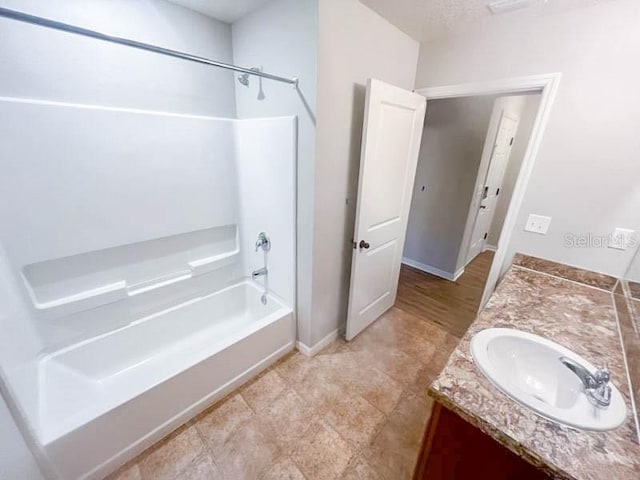 bathroom with vanity and bathing tub / shower combination