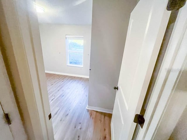 hallway with light hardwood / wood-style flooring