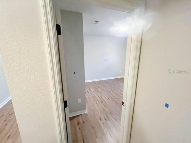 corridor with light wood-type flooring