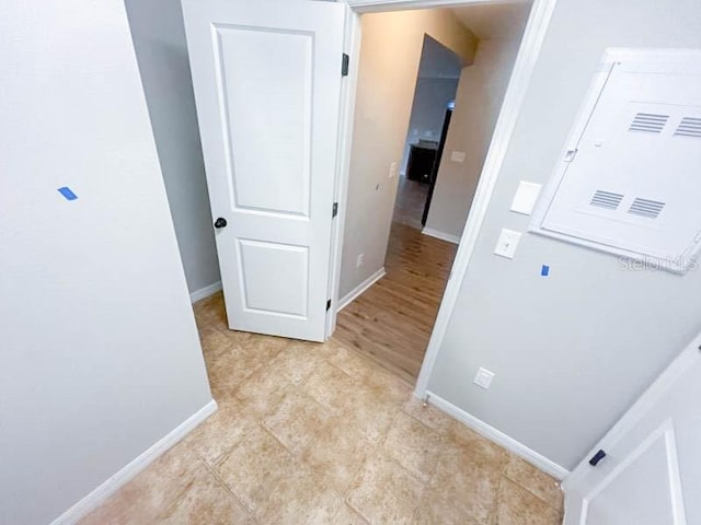 hall with light tile patterned floors