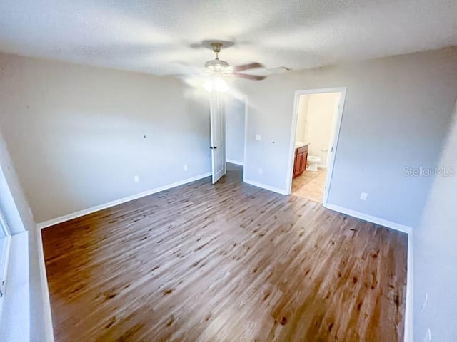 spare room featuring a textured ceiling and light hardwood / wood-style flooring