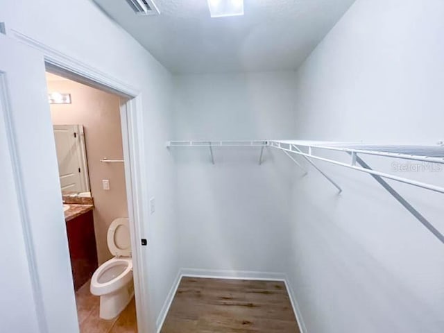 spacious closet featuring hardwood / wood-style flooring