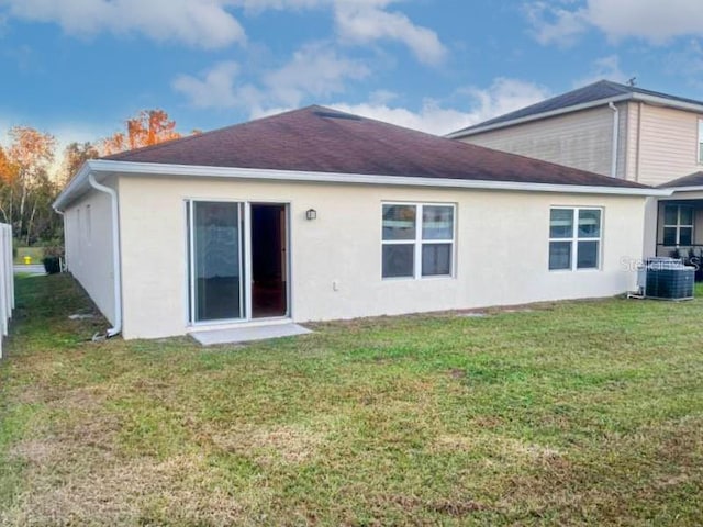 rear view of property with a lawn