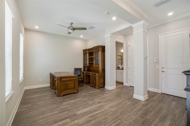 office area with ornate columns, ceiling fan, dark hardwood / wood-style flooring, and crown molding