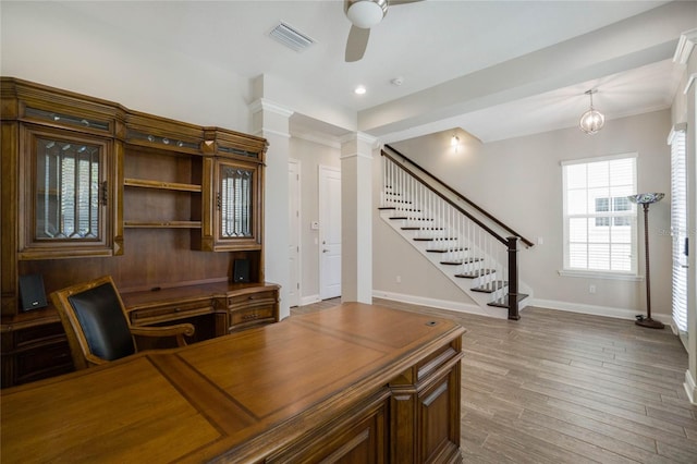 office featuring wood-type flooring, ceiling fan with notable chandelier, and crown molding