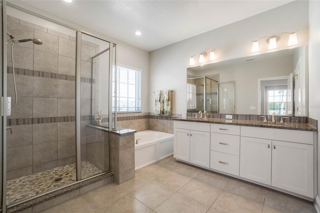 bathroom with tile patterned flooring, vanity, shower with separate bathtub, and a wealth of natural light