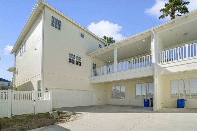 back of house featuring a garage and a balcony