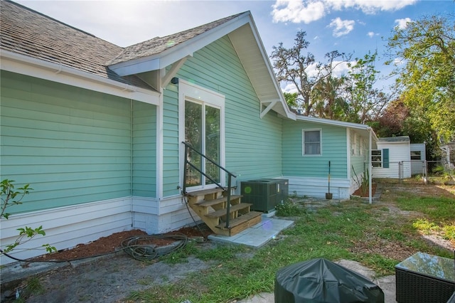 back of property featuring central air condition unit