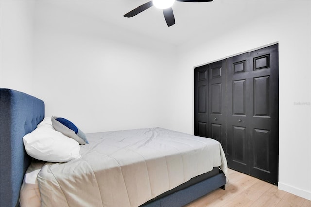 bedroom with ceiling fan, a closet, and light hardwood / wood-style floors