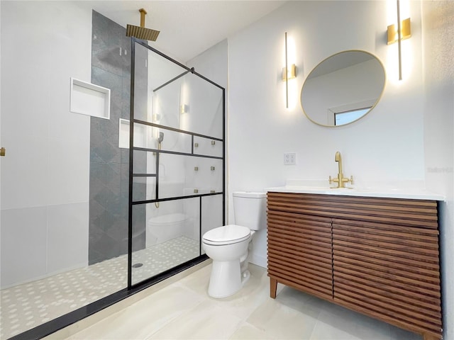 bathroom featuring tiled shower, vanity, toilet, and tile patterned flooring