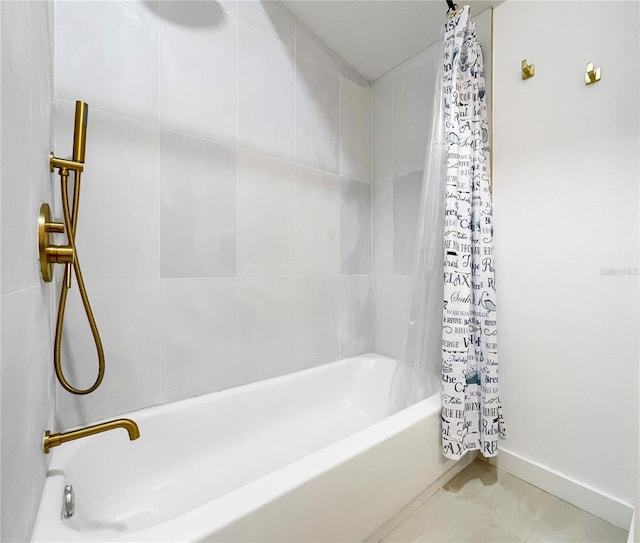 bathroom featuring tile patterned flooring and shower / bath combo