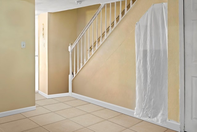 stairway featuring tile patterned floors