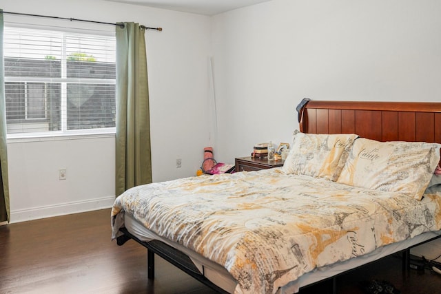 bedroom with dark wood-type flooring