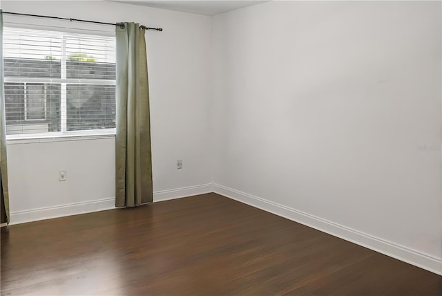 unfurnished room with dark hardwood / wood-style floors