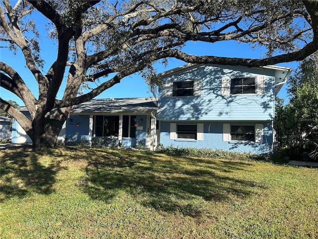 tri-level home with a front lawn