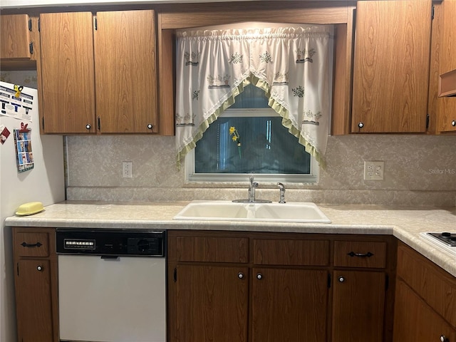 kitchen featuring tasteful backsplash, sink, and white appliances