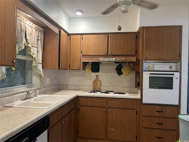 kitchen with tasteful backsplash, white appliances, ceiling fan, and sink