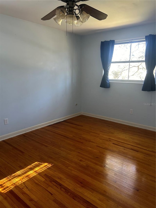 spare room with hardwood / wood-style floors and ceiling fan