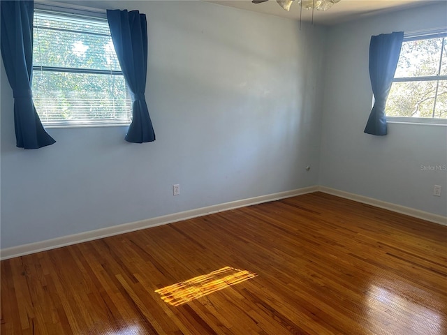 unfurnished room featuring hardwood / wood-style flooring and ceiling fan