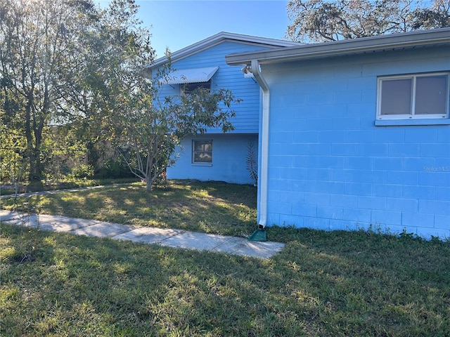 view of property exterior with a yard