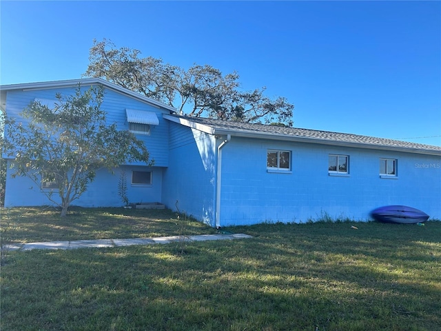 view of side of home featuring a lawn