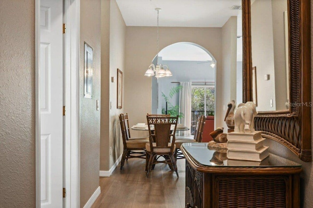 interior space with a chandelier and wood-type flooring