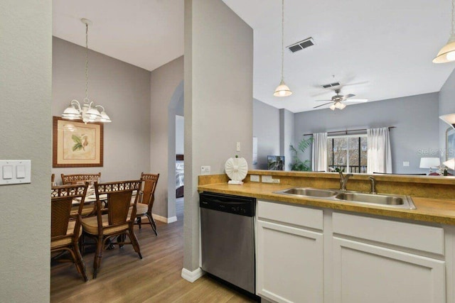 kitchen with sink, light hardwood / wood-style flooring, stainless steel dishwasher, decorative light fixtures, and white cabinets