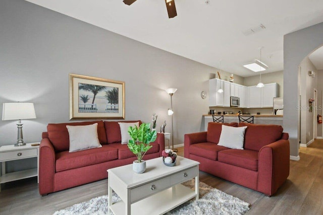 living room featuring ceiling fan and hardwood / wood-style flooring